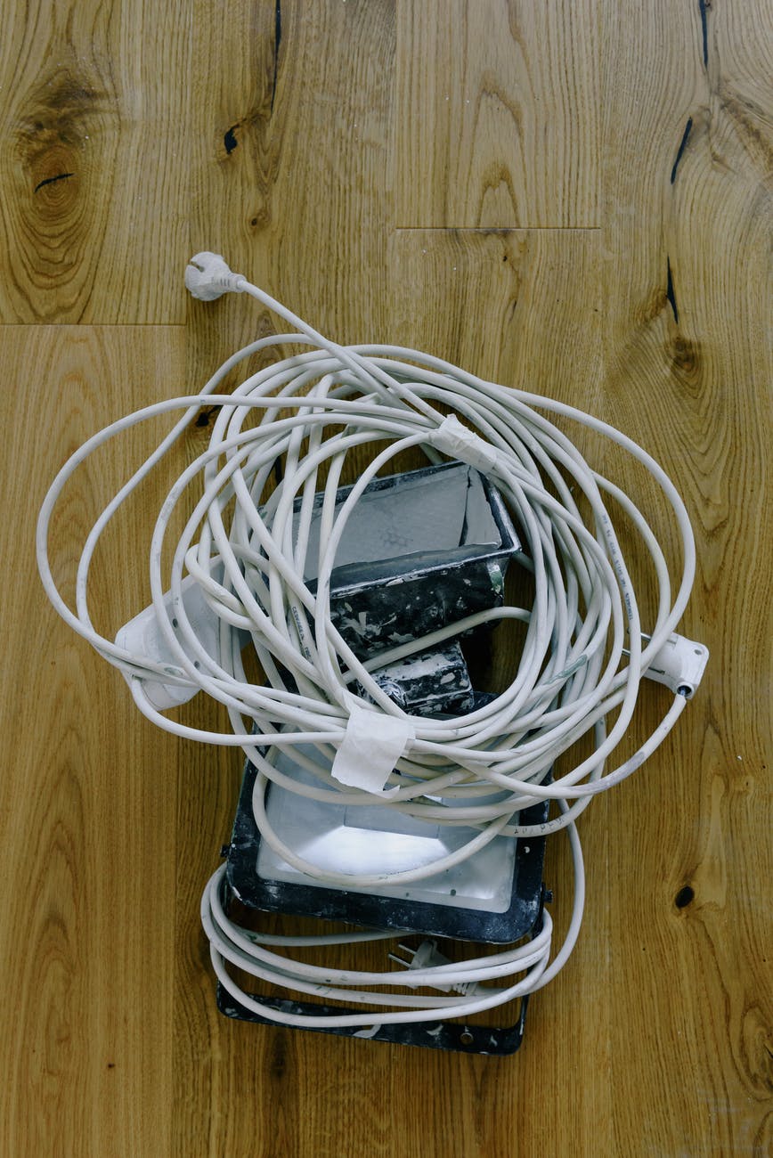 projectors with cords on wooden floor